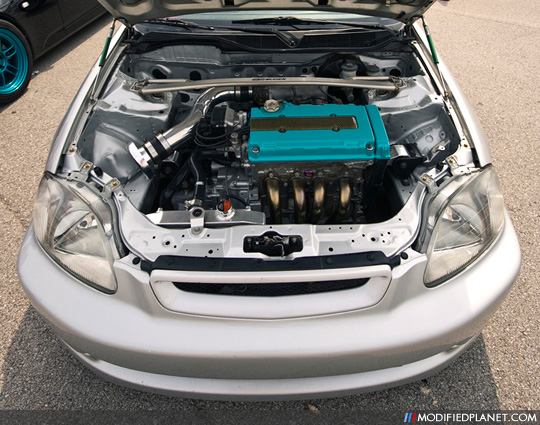 Silver EM1 Honda Civic with a wire tucked B16 engine accented with a Mugen 